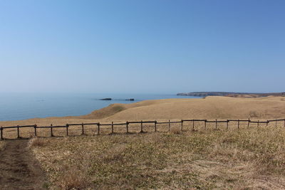 Scenic view of sea against clear blue sky