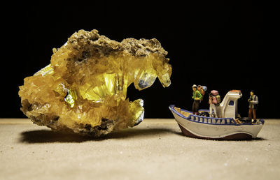 Close-up of food on table against black background