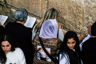 Group of people against wall