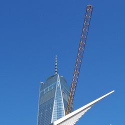 Low angle view of tower against blue sky