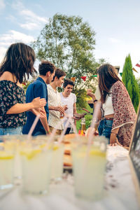 Friends having leisure time together at backyard