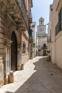 Street amidst buildings in city against sky