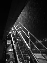 Low angle view of illuminated bridge at night
