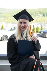 Portrait of woman wearing graduation gown