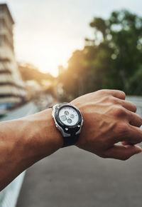 Cropped hand of man holding pocket watch