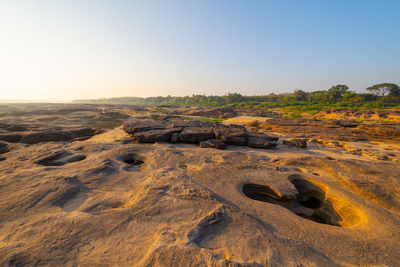 Scenic view of landscape against clear sky during sunset