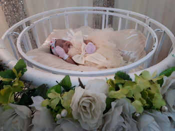 Cute baby girl sleeping on decorated bed