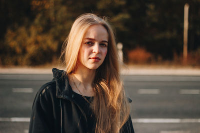 Portrait of beautiful young woman standing outdoors