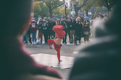 Rear view of people walking outdoors