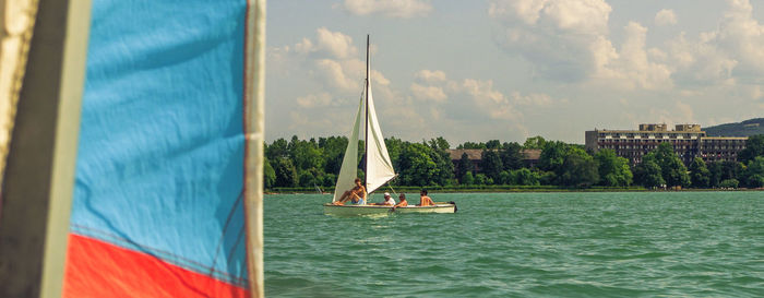 Sailboat sailing on sea against sky