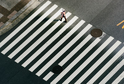 High angle view of woman walking on road