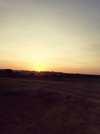 Scenic view of field against sky during sunset