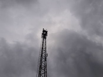 Low angle view of communications tower against sky