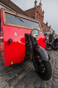 Red vintage car on street in city