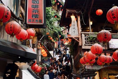 Lanterns hanging on street in city