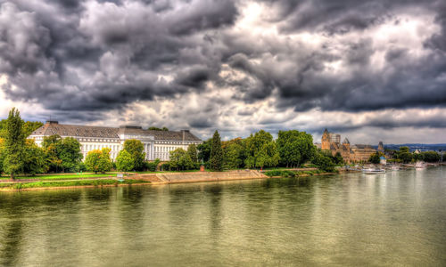 Scenic view of river against cloudy sky