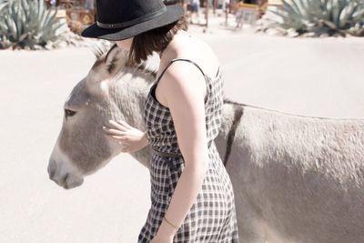 Woman petting donkey