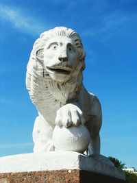 Low angle view of statue against blue sky