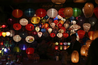 Low angle view of illuminated lanterns for sale at market