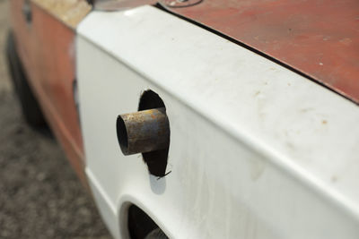 Muffler pipe in race car. cut hole for exhaust pipe in car. modernized transport.