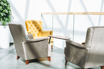 Coffee table with armchairs at open space in the office, interior of coworking