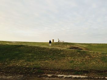 People on field against sky