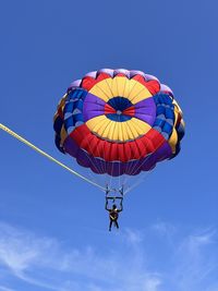 Low angle view of hot air balloon against blue sky