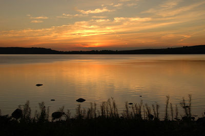 Scenic view of lake at sunset