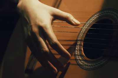 Detail shot of hand playing the guitar