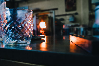 Close-up of illuminated candles on table