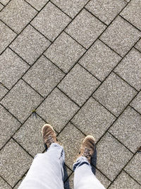 Rear view of woman standing on footpath