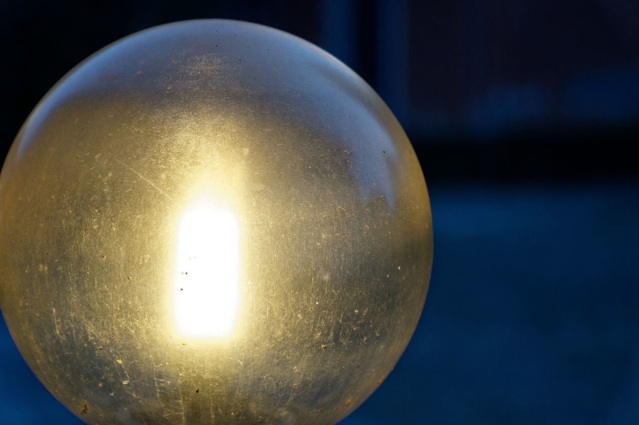 ILLUMINATED LIGHT BULB AGAINST SKY AT NIGHT