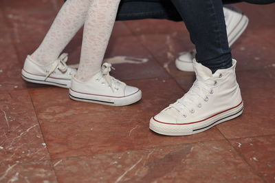 Low section of person standing on tiled floor