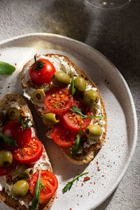 Plate with bruschettas and glass of wine