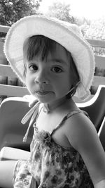 Close-up portrait of girl sitting on chair