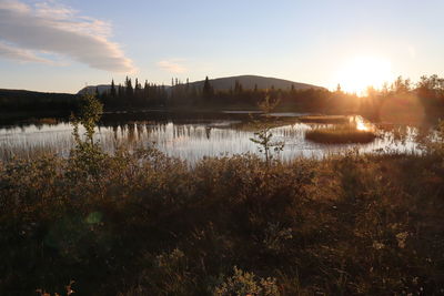 Scenic view of lake against sky during sunset