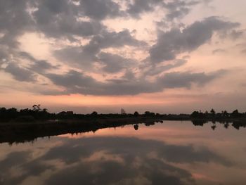 Scenic view of lake against sky during sunset