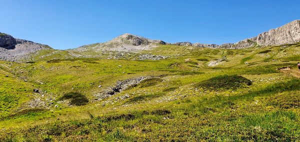 Scenic view of mountains against clear blue sky
