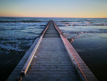 Scenic view of sea against clear sky during sunset