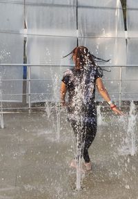 Full length of woman jumping in water