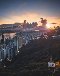 High angle view of illuminated cityscape against sky at sunset