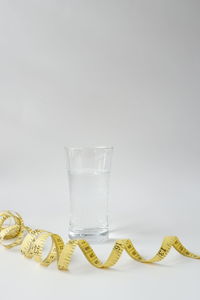 Close-up of drink on table against white background