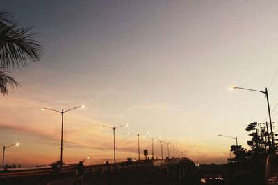 Traffic on road at sunset