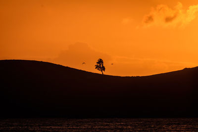 Scenic view of silhouette land against sky during sunset