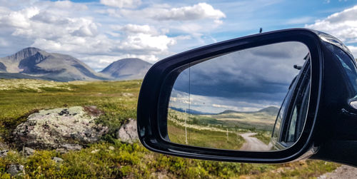 Reflection of road on side-view mirror