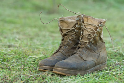 Close-up of old shoes on field