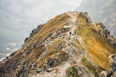 Aerial view of hikers on mountain against sky