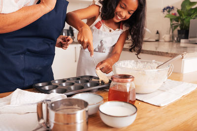 Midsection of woman preparing food at table