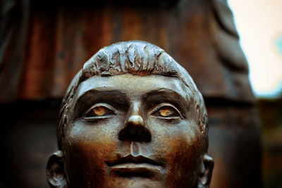 Bronze statue of a girl, eyes of a child made of iron. hope. future. past.