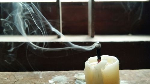 Close-up of lit candles on table